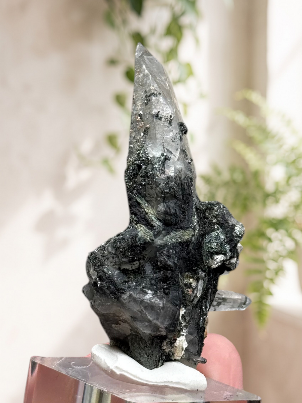 Crystal Glade laser quartz specimen from Balochistan with a long tapering point and dark mineral inclusions
