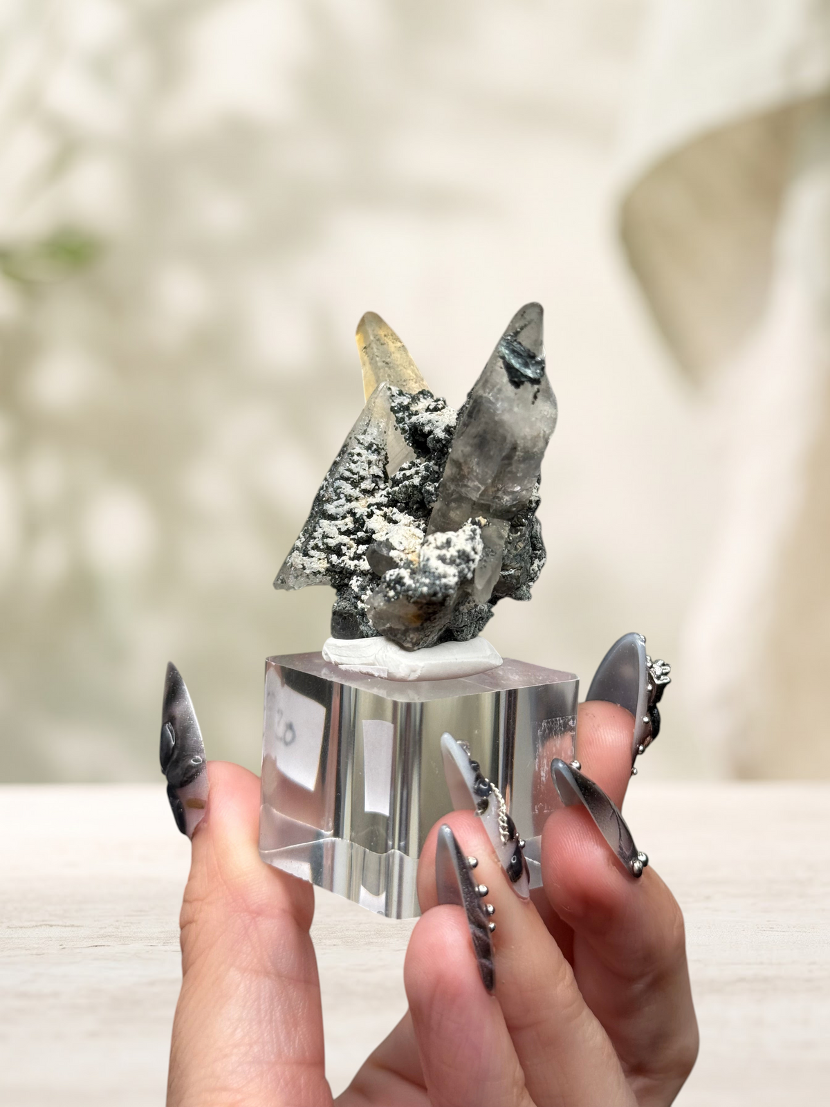 Crystal Glade laser quartz specimen from Balochistan, Pakistan, featuring slender crystals on a dark mineral matrix.
